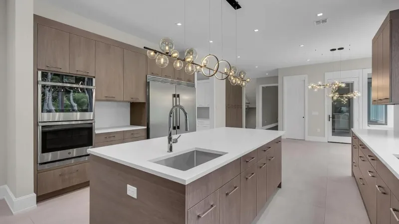 Modern oak kitchen with large island and statement lighting
