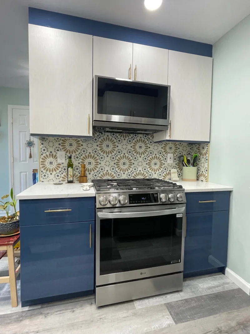 Two-tone blue and white kitchen with patterned backsplash