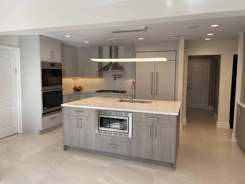 Grey modern kitchen with quartz waterfall island